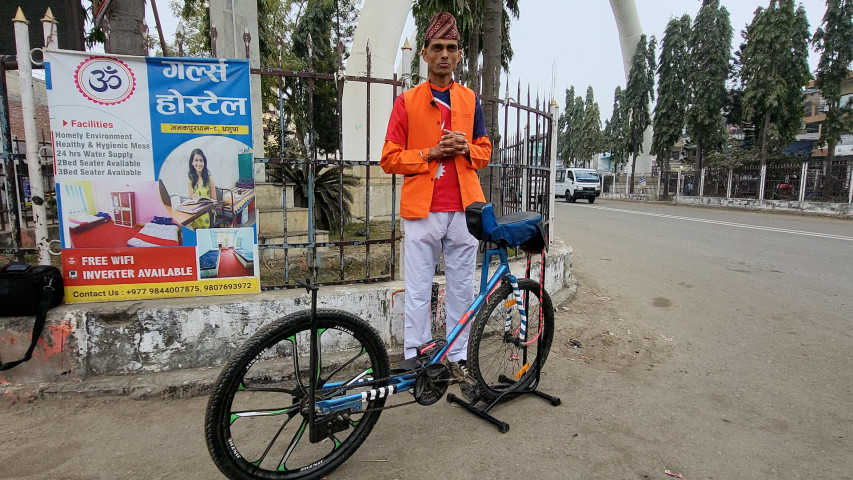 Public Health Worker Promotes Nature Protection by Riding a Bicycle Backwards